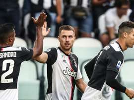 Welsh midfielder Aaron Ramsey (C) scored on his first start for Juventus along with Cristiano Ronaldo (R).